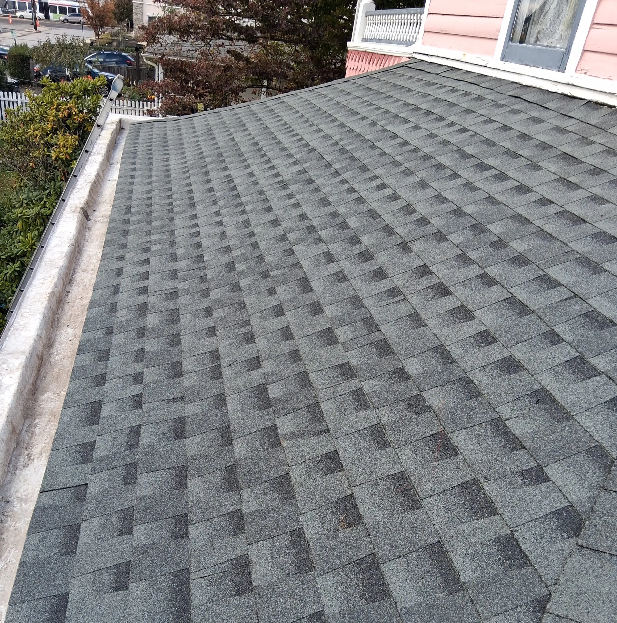 Newly installed gray asphalt shingle roof on a residential home.