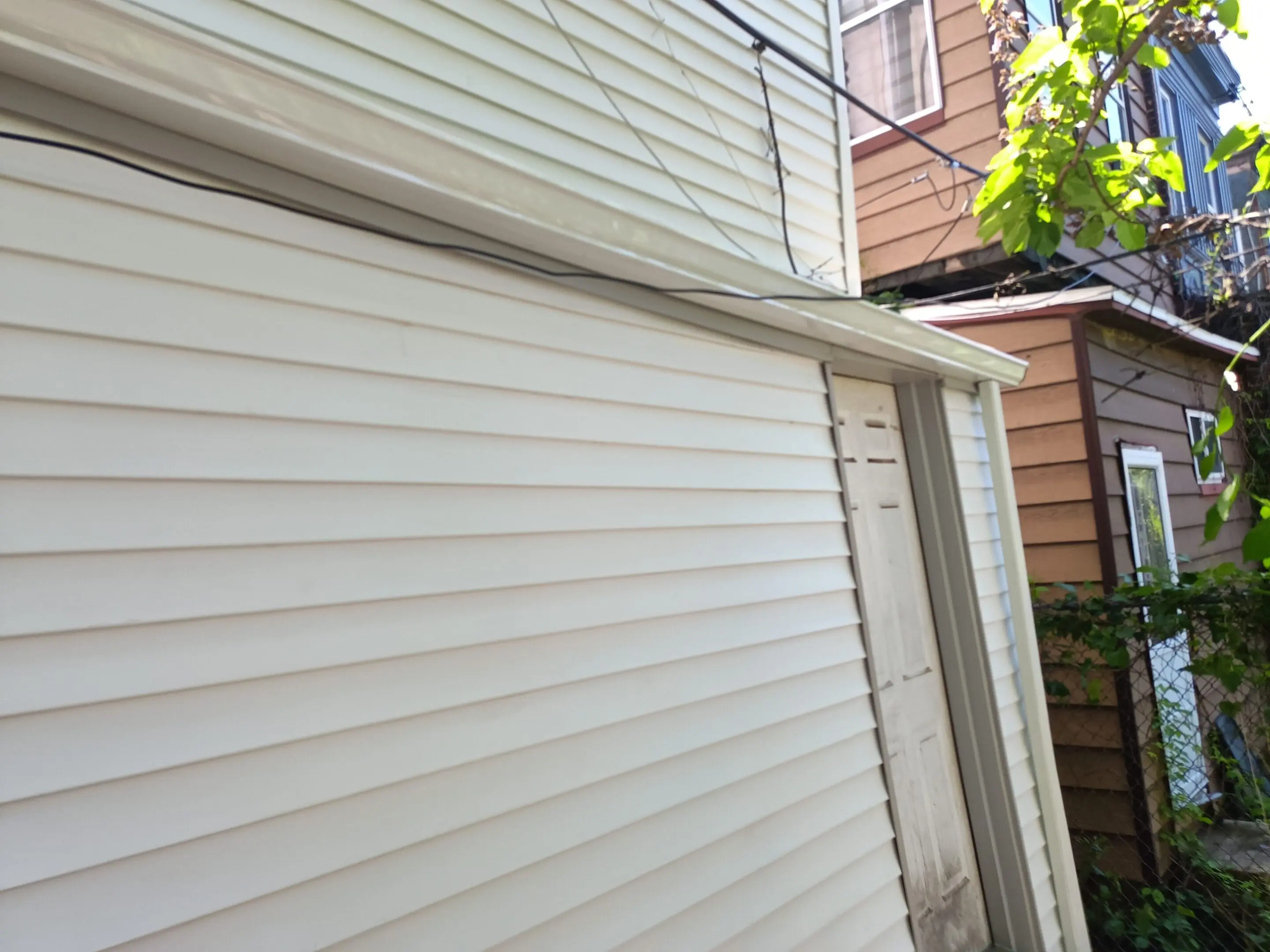 Siding repair or installation in progress on a house exterior.