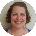 Smiling woman with curly hair in a round frame.